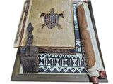 a wooden box with a book, a brush, and a piece of paper