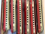 four trains in a wooden box on a white surface