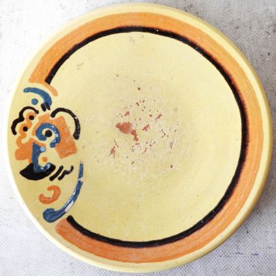 a yellow plate with a blue and orange design on it