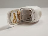 a broken cell phone sitting on a white table