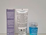 the bottle of water is next to a tube of lotion on a table