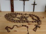 a rosary, a cross, and a rosary on a wooden table