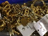 a box full of gold and silver jewelry on a table