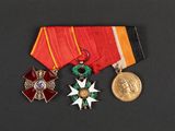 three medals and a medal on a black surface