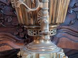 a gold vase sitting on top of a black table