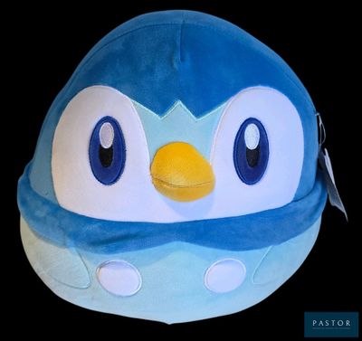un bonnet en forme de pingouin bleu et blanc avec un bec jaune