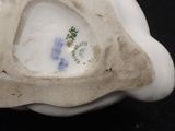 a white vase with a blue and green design on it
