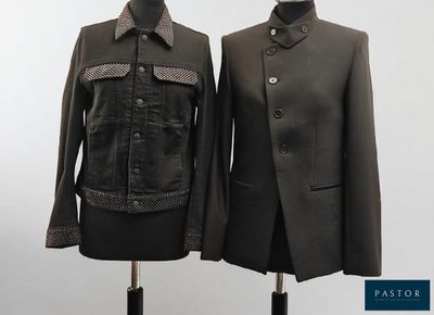 two mannequins dressed in black and brown clothing on a mannequin stand