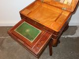 a small wooden table with a mirror on top of it