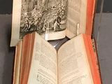 an open book sitting on top of a wooden stand