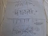 a sheet of paper with drawings on it on a bed