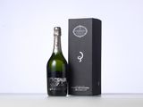 a close up of a bottle of champagne next to a box