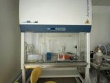 a lab with a yellow chair and a yellow trash can