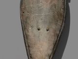 a close up of a piece of wood with holes in it