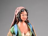 a figurine of a woman in a green dress