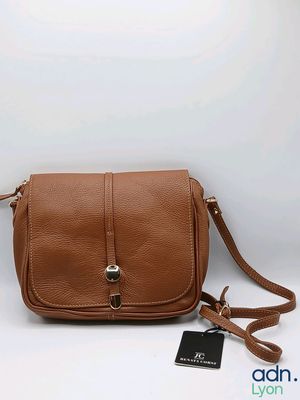 a brown purse with a tag on the side of it