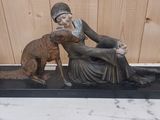 statue représentant une femme assise sur une table avec un chien