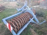 a blue machine that is sitting in the grass