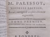 an open book with a black and white image of a man ' s hand holding a book