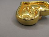 a gold object that is sitting on a table