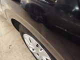 a close up of a car ' s front bumper and tire