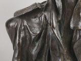 a close up of a statue of a woman with a hat on