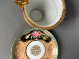 two cups and saucers are sitting on a table next to each other