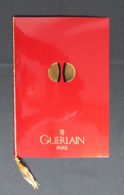 the red book is open on a table with a gold tassel