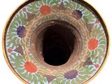 a vase that has a flower design on it