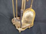 a gold broom and a broom brush on a stand