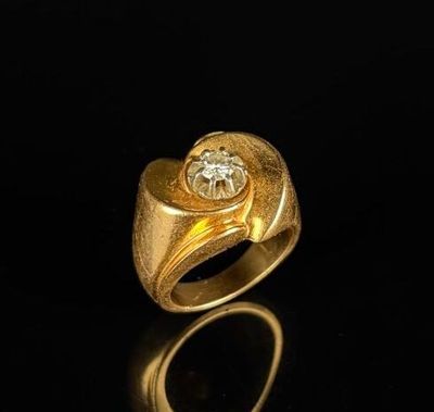 a close up of a gold ring with a diamond on it