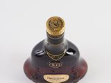 an image of a bottle of brandy sitting on a white surface