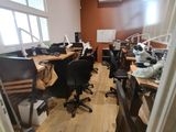 a room with a lot of desks and chairs in it