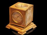 a clock that is sitting on top of a wooden stand