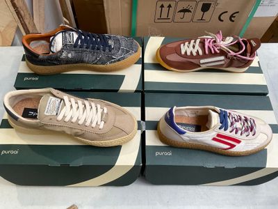 several pairs of shoes are sitting on a box on a table