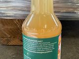a bottle of orange juice sitting on the floor