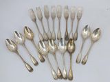 a lot of silver spoons and forks on the table