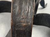 a close up of a metal object with a wooden handle