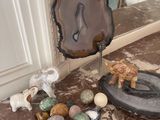 a table with a mirror and some rocks and a figurine