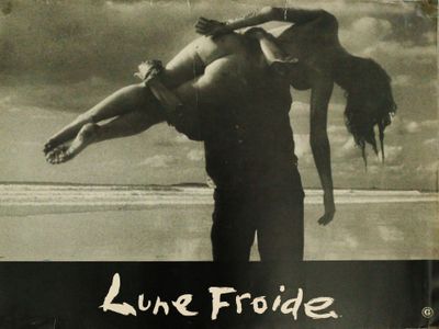 a black and white photo of a man carrying a woman on his back