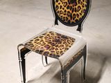 a chair that has a leopard print seat on it