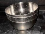 a metal bowl that is sitting on a counter