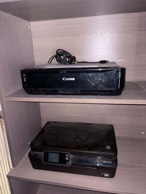 a small shelf with a printer and other electronics on it