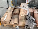 a pile of roof tiles on a pallet in a warehouse