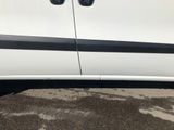 a white van with black stripes parked in a parking lot