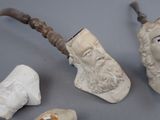 a statue of a man with a beard and a pipe next to other items