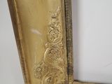 a picture of a gold frame with a picture on it