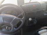 a steering wheel and dashboard of a vehicle in a parking lot