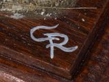 a picture of a wooden table that has a sign that says r on it