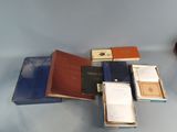 a lot of books and a clock on a table